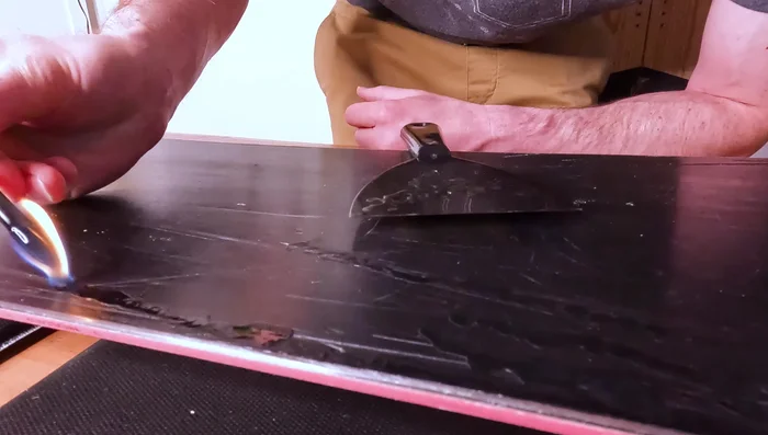 Apply wax to the base of the snowboard and leave it on for the off-season.
