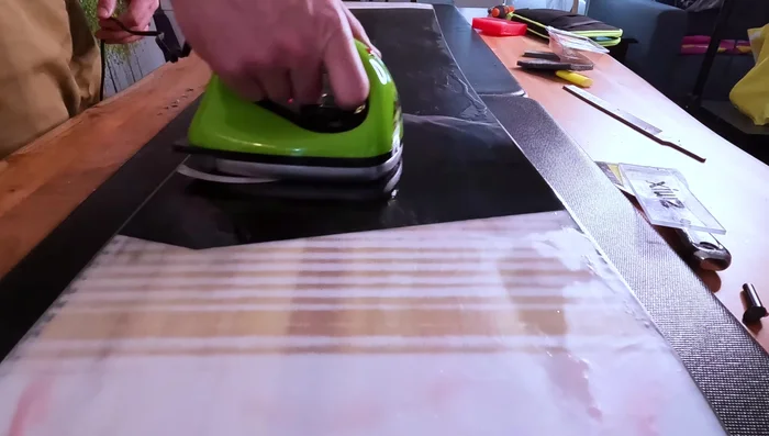 Apply wax to the base of the snowboard and leave it on for the off-season.