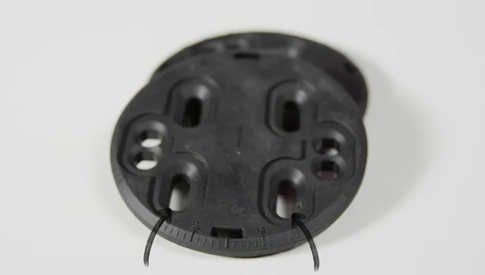 Insert the 4x4 disc into the binding, ensuring the holes closer to the edge are towards the front (toe side). Align the center degree marking on the disc with the center marking on the binding post (zero degree position).