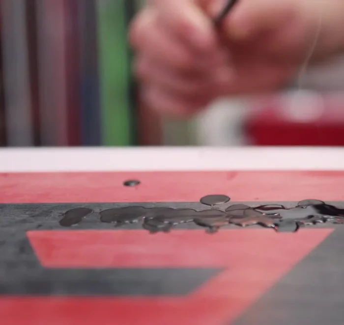 Use a metal or plastic scraper to further smooth the repair until it's flush with the base.