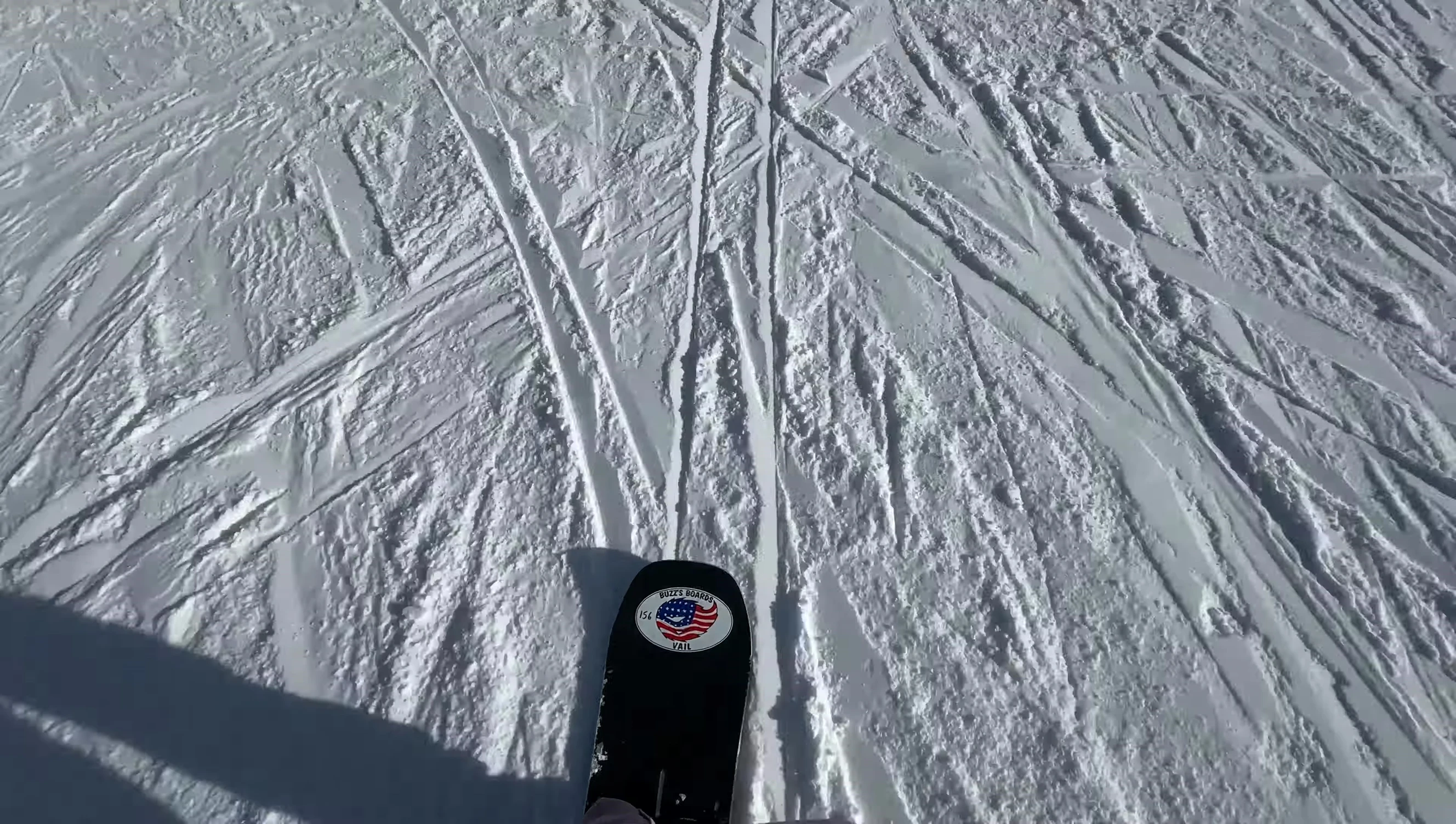 Rider performing one-footed riding on the Burton Custom snowboard