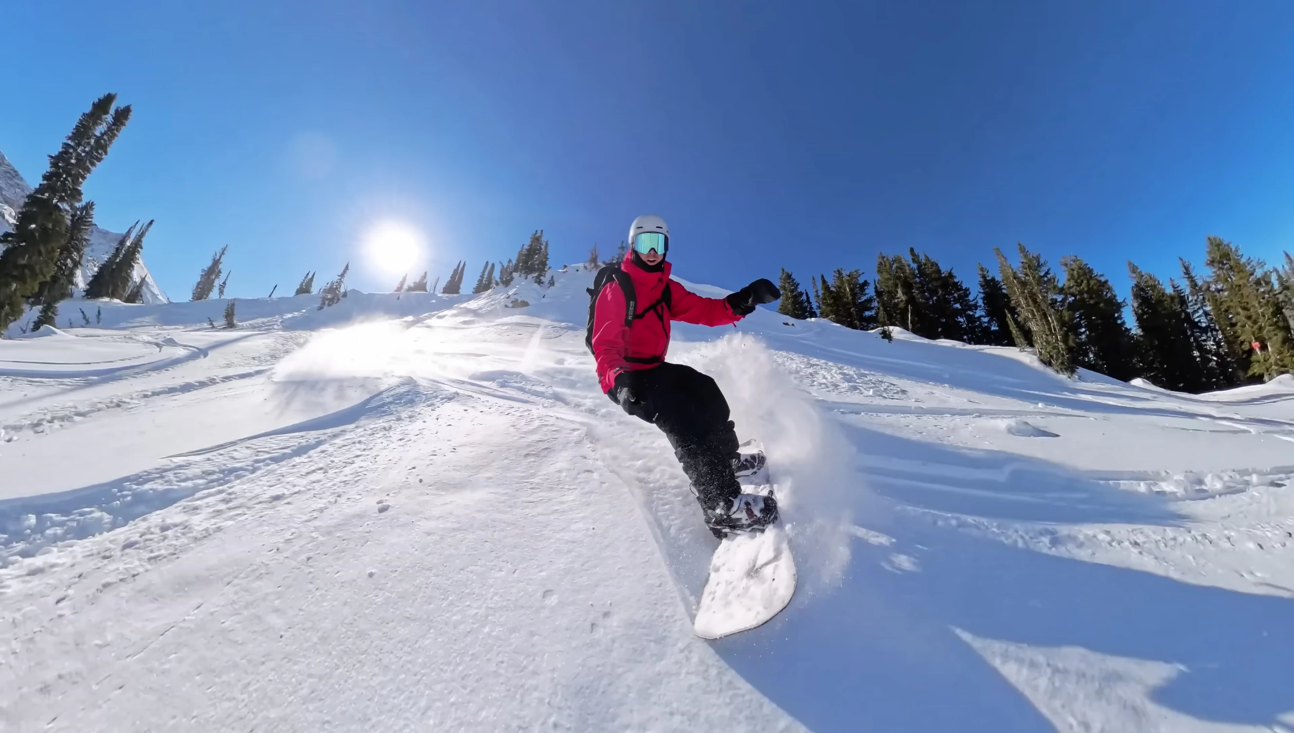 Rider gliding smoothly through deep powder on the Orca.