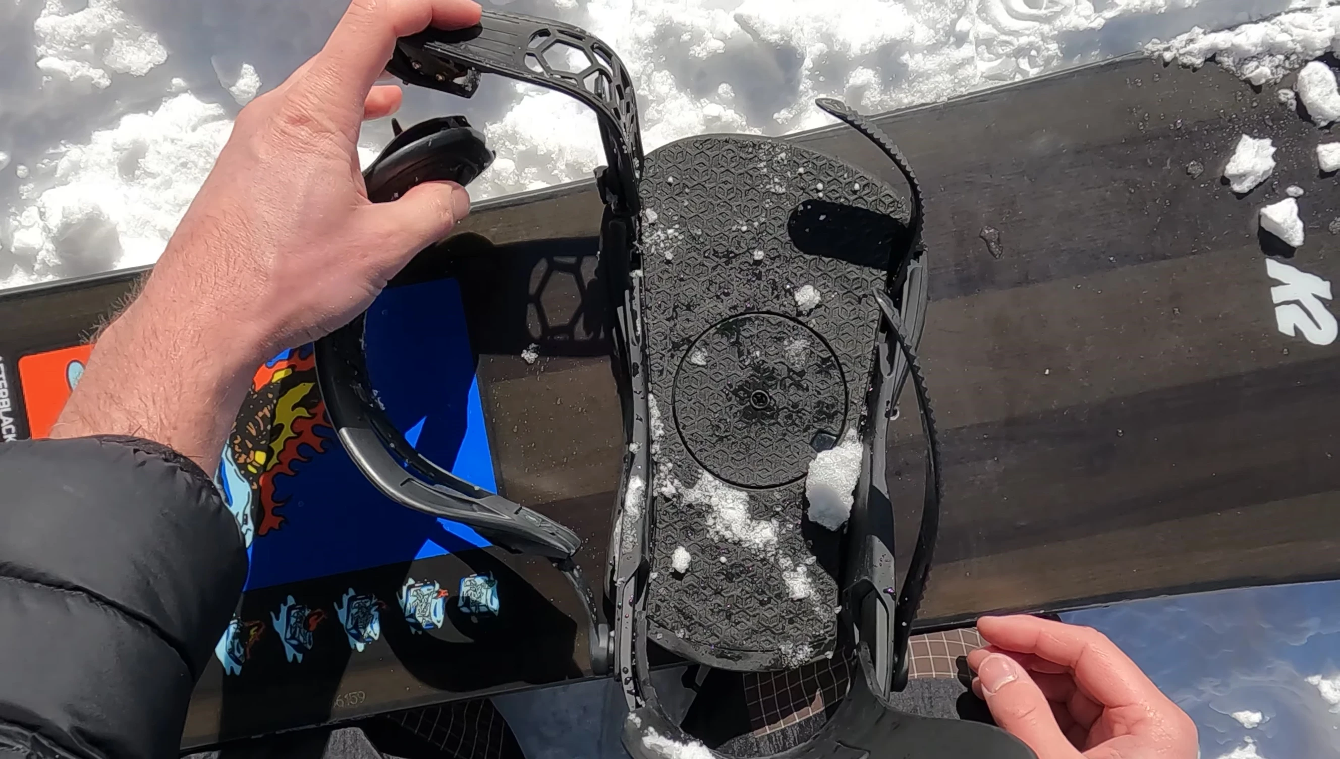 Snowboarder showcasing snowboard and bindings