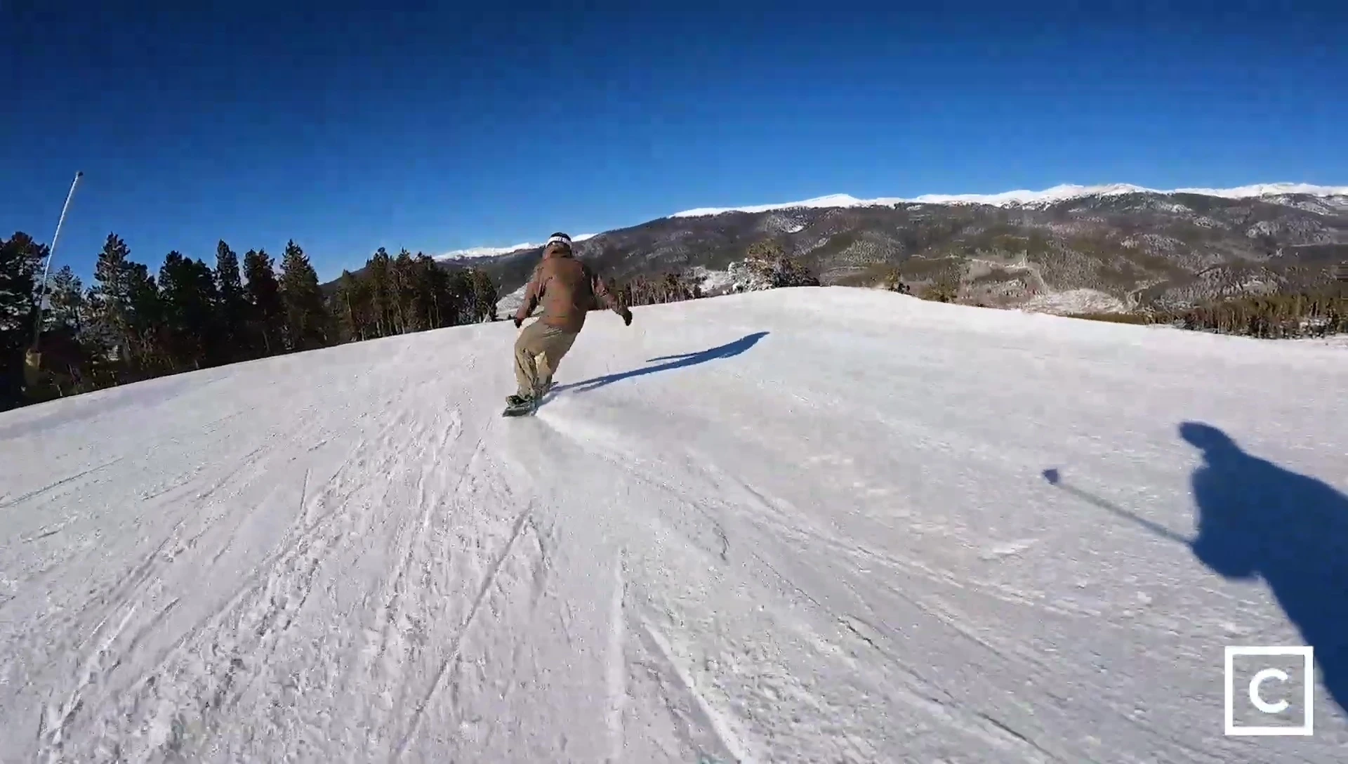 Rider confidently riding down a steep slope, conveying a sense of trust in the board.
