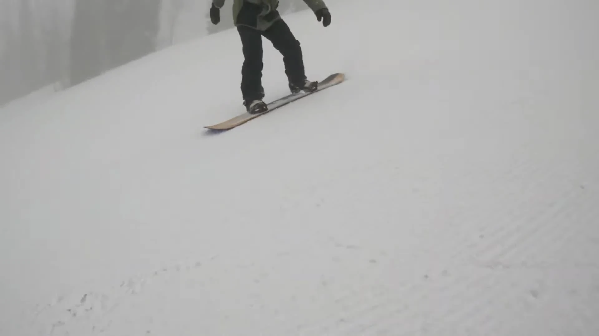The reviewer introducing the Salomon Assassin snowboard.