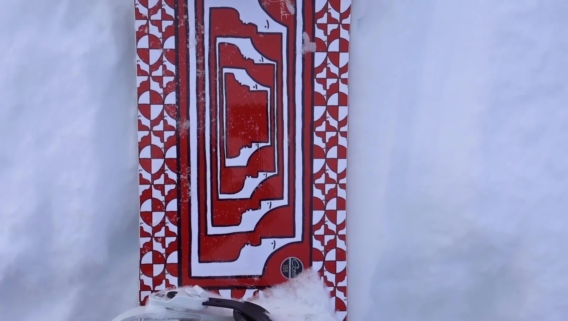 Close-up shot highlighting the asymmetrical shape of the GNU Space Case snowboard.
