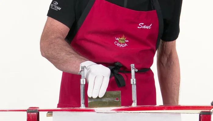 Use a petroleum jelly-coated steel scraper to further flatten and level the surface. Clamp and press down. Wait for curing.