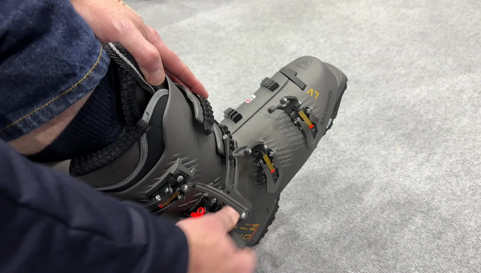 Demonstrating how easily the boot comes off using the double buckle release.