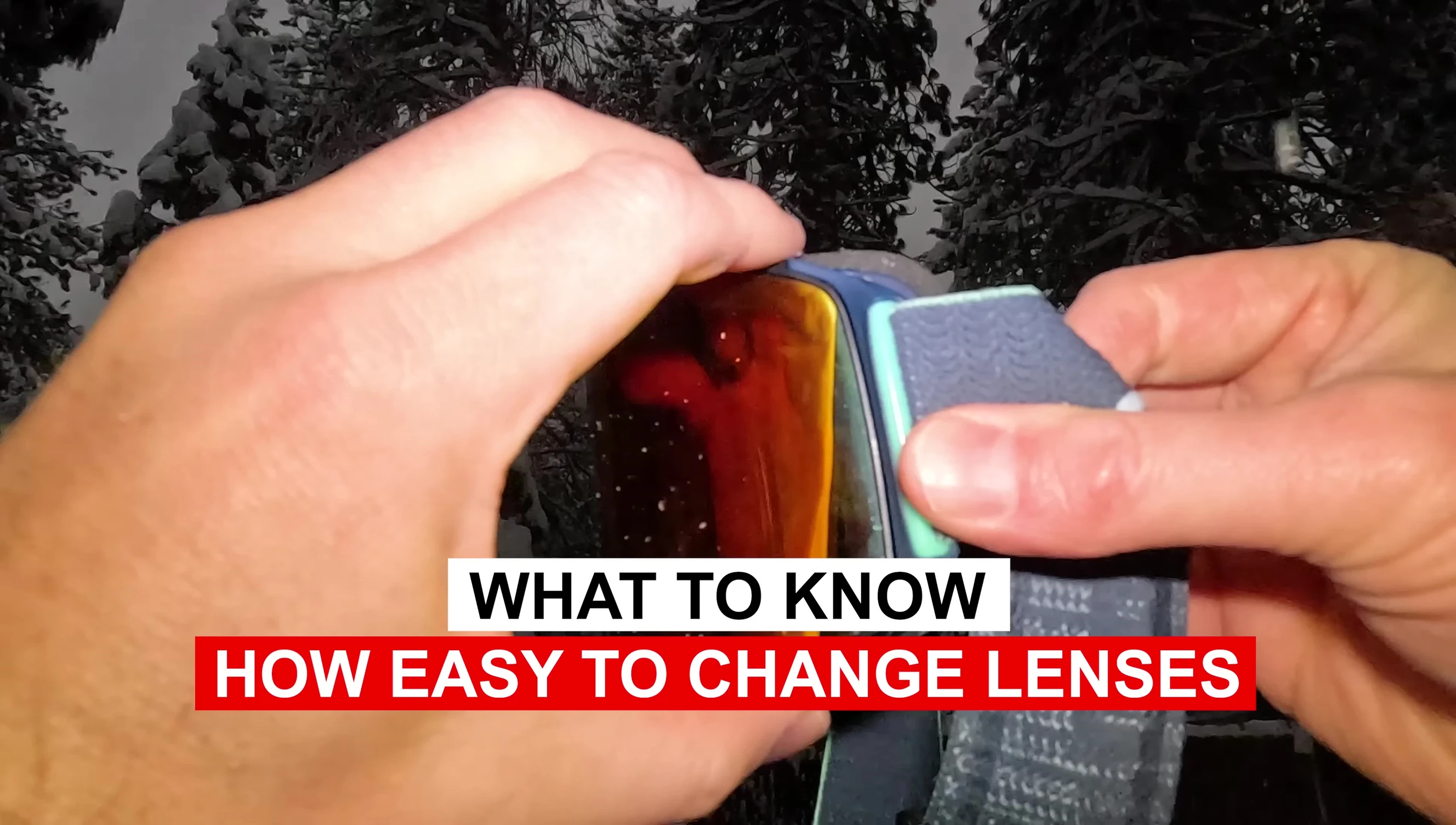 Hands demonstrating the easy process of changing lenses on a snowboard goggle.