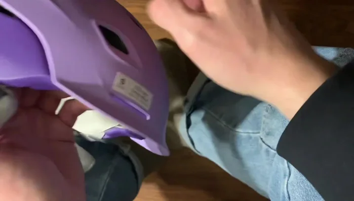 Pull the earpad from the front towards the brim of the helmet.