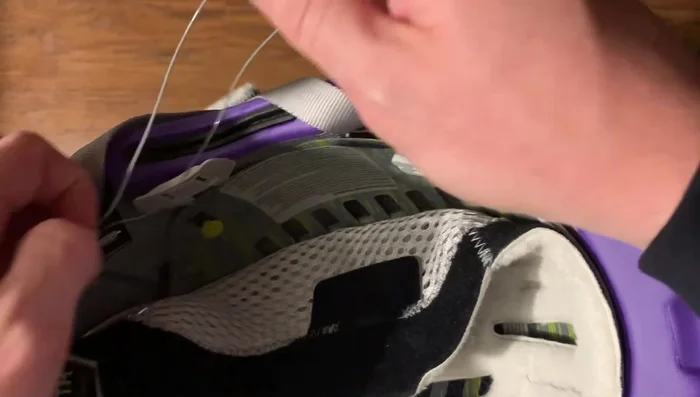 To reattach, pinch the wire connection point and guide the wire under the securing piece.