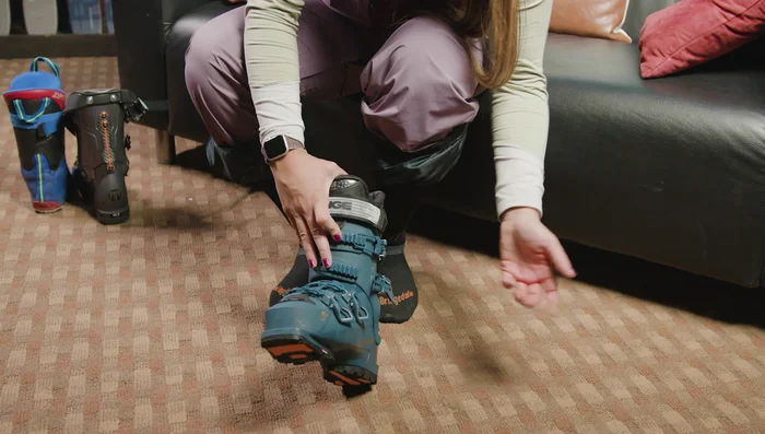 Pull the tongue to the side and use your thumb to move the plastic piece out of the way to create a wider entrance.