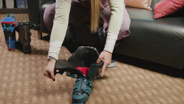 Pull the tongue to the side and use your thumb to move the plastic piece out of the way to create a wider entrance.