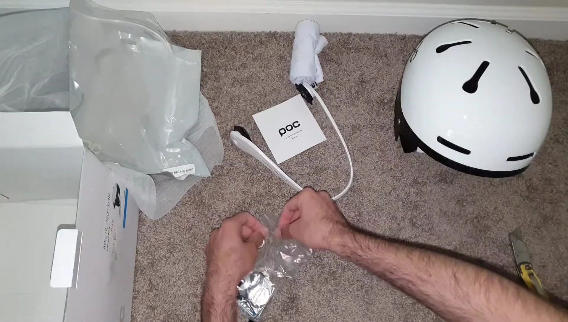 Removing the retaining screw and opening the helmet's access panel.