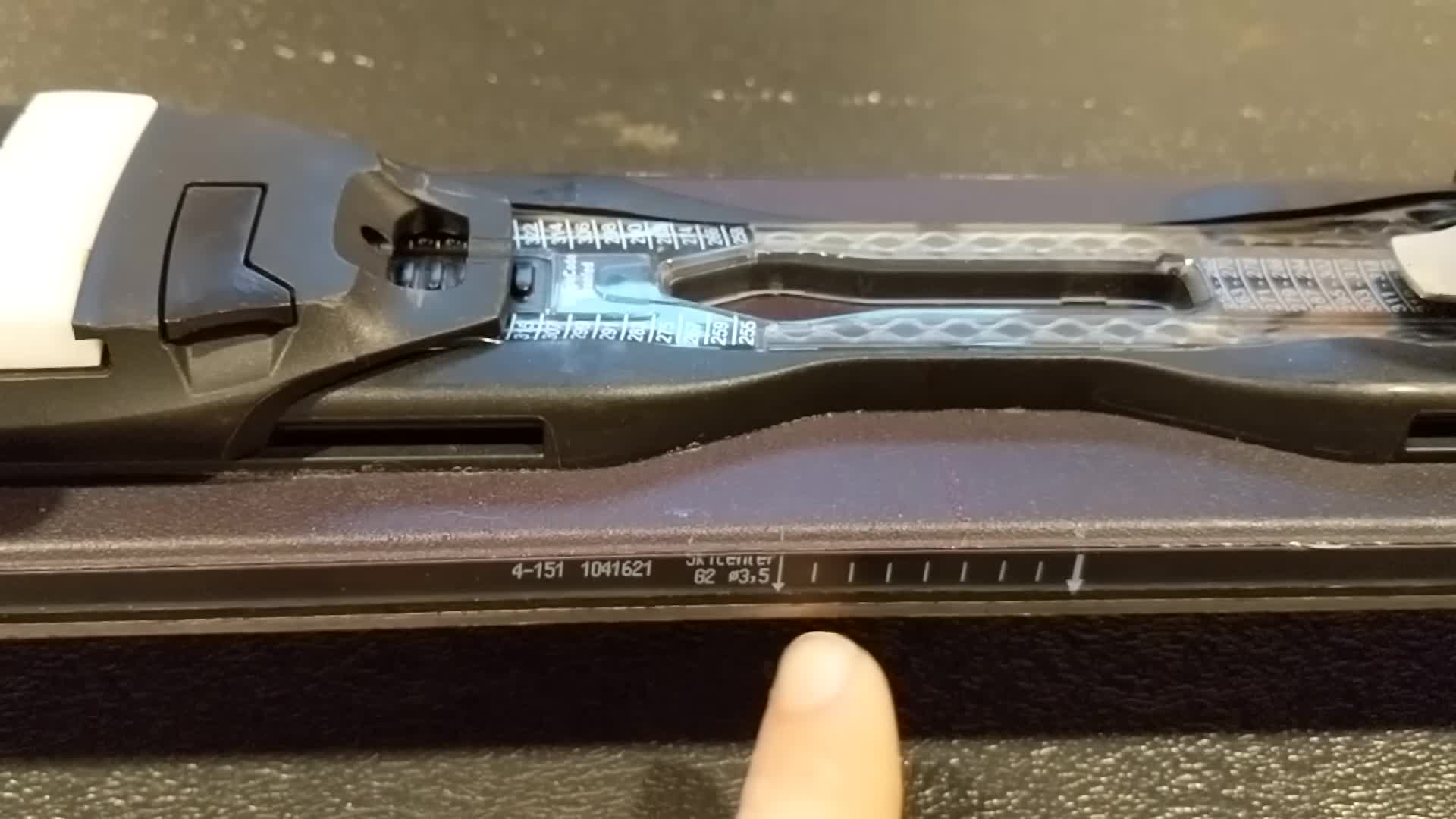 Marking the center of the ski for binding placement.