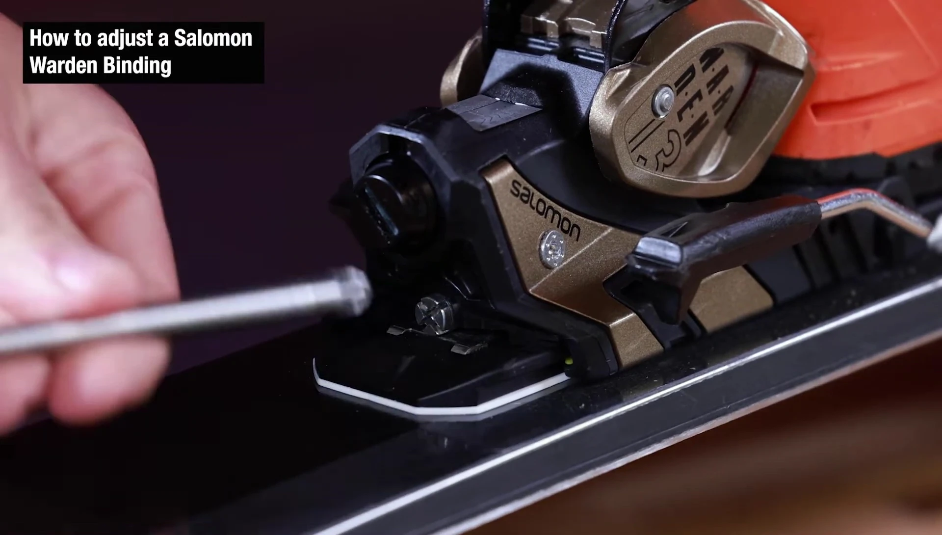 Person using a Phillips head screwdriver to adjust the forward pressure screw.