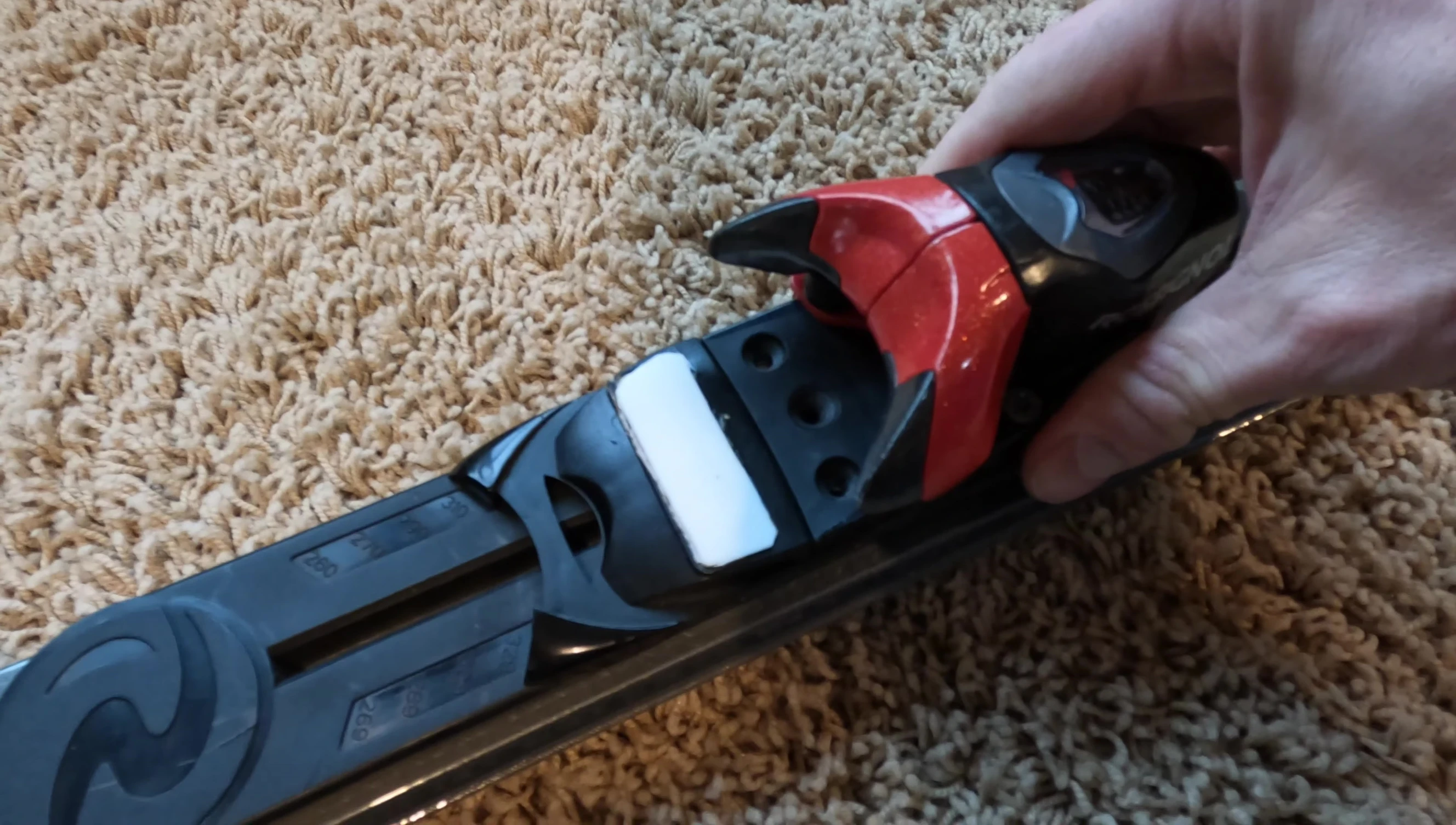 The top part of the binding and the track system detached from the base.