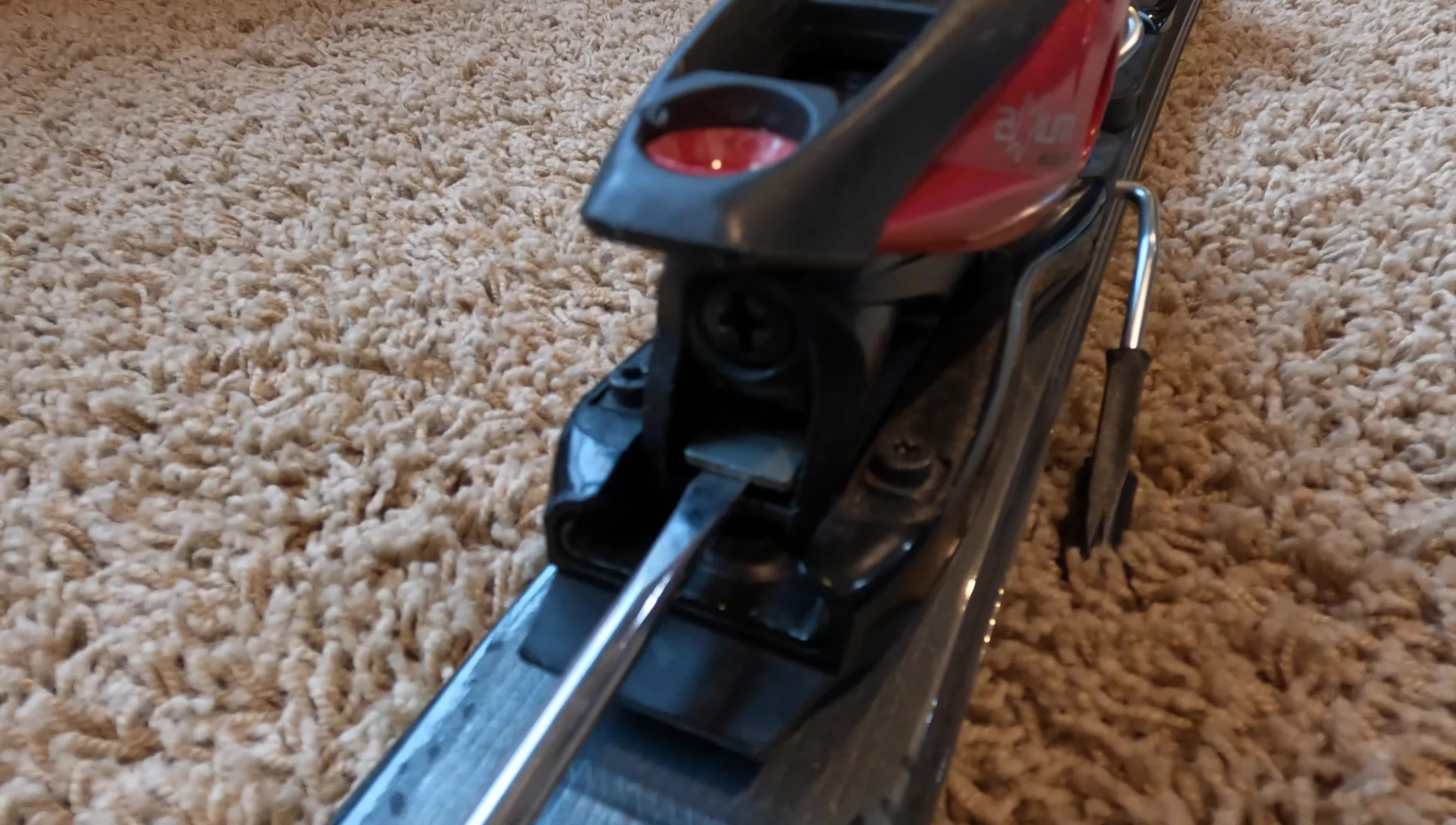 Using a flathead screwdriver to release the lever on the heel piece.