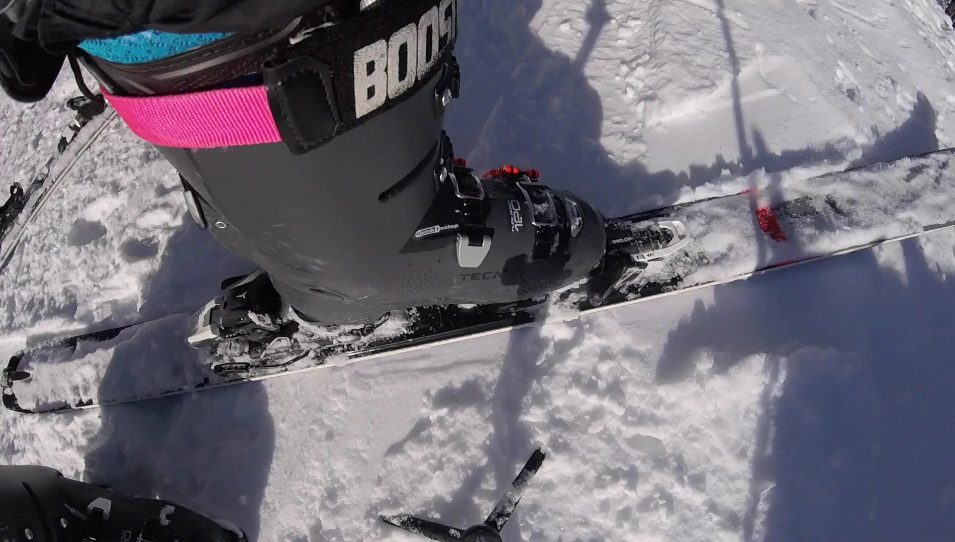 Demonstrating how to move the binding to remove ice and secure it properly.