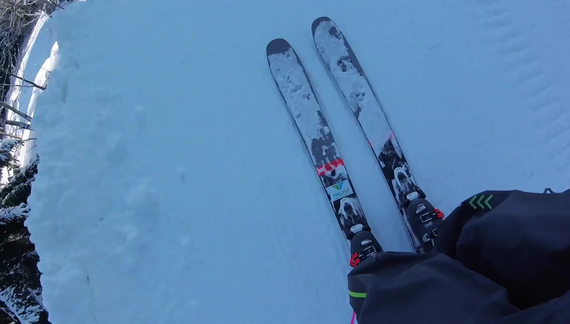 Skier enjoying a downhill run after transitioning to downhill mode.