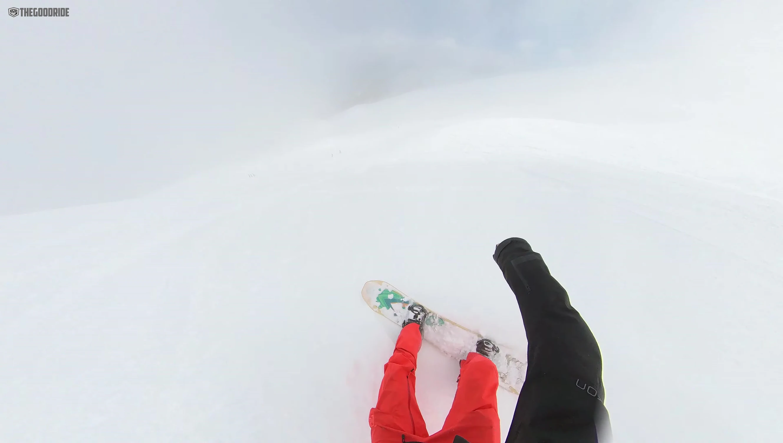 Snowboard riding through powder