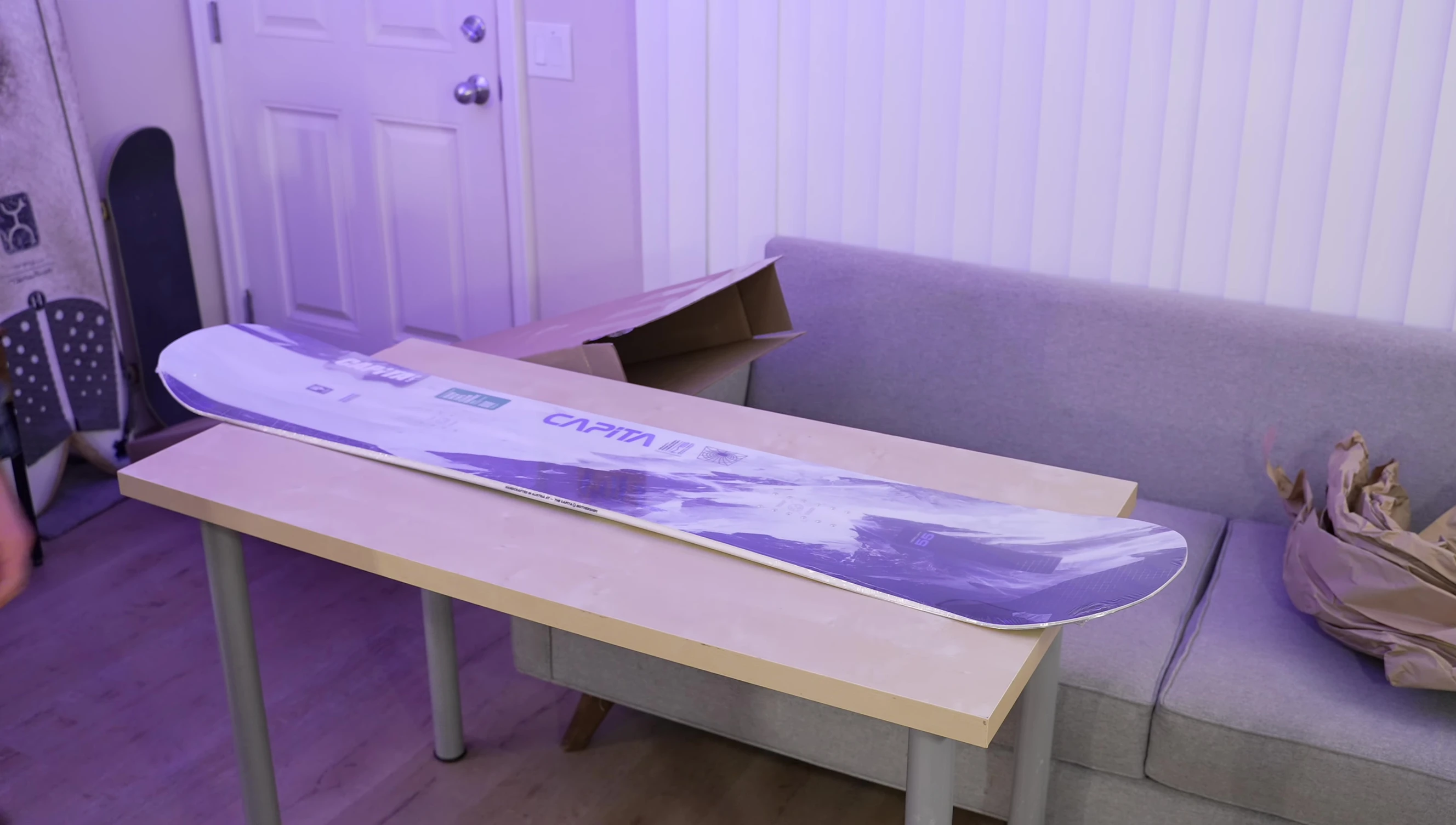 The snowboard being taken out of the box