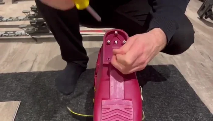 Remove old screws from the broken heel plastic using a screwdriver.