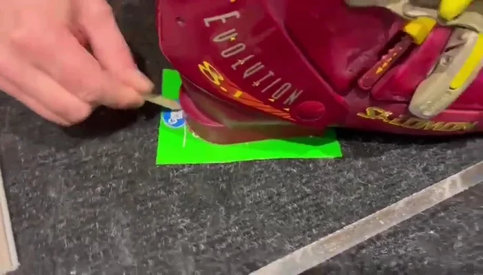 Create a template: Place the boot on cardboard, trace the broken plastic area with a pencil, and cut out the template using scissors.