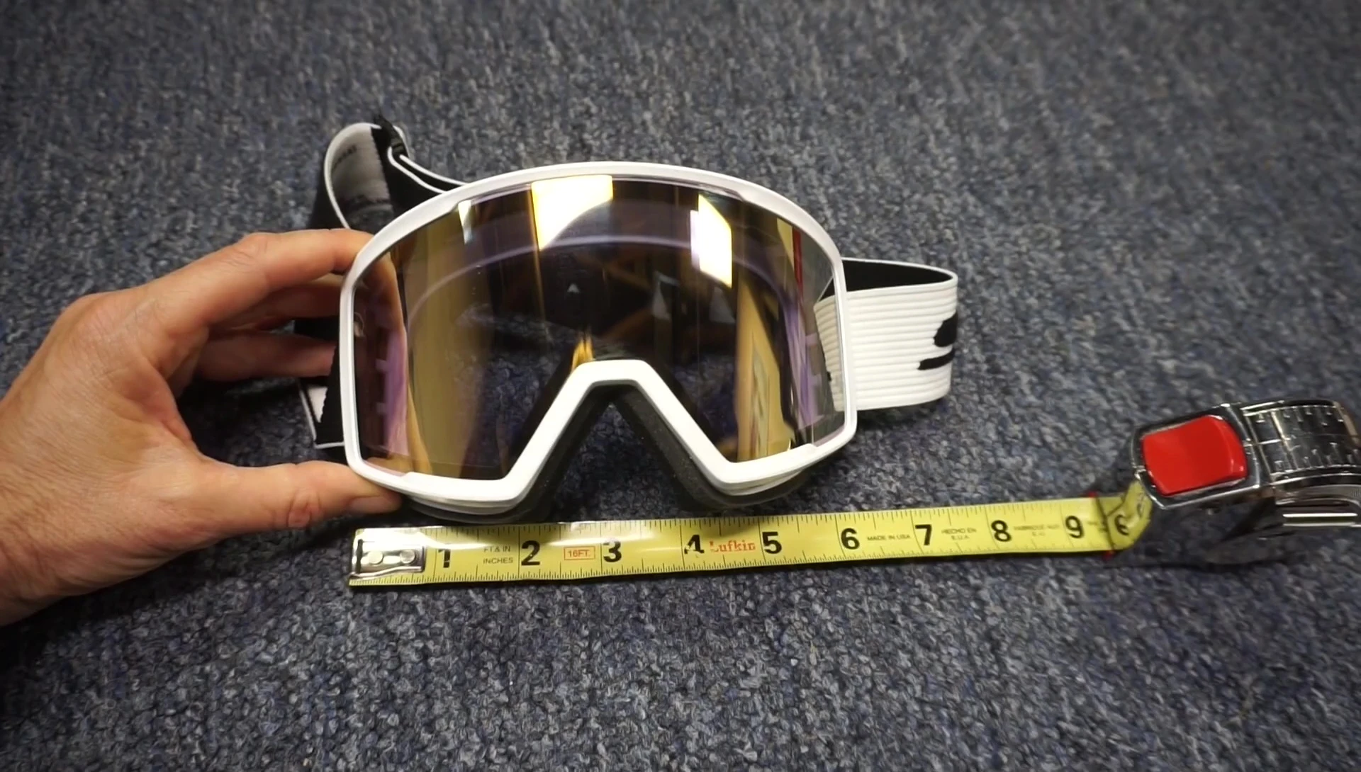 Shot showing the dimensions of the goggles, perhaps with a ruler or measuring tape for reference.