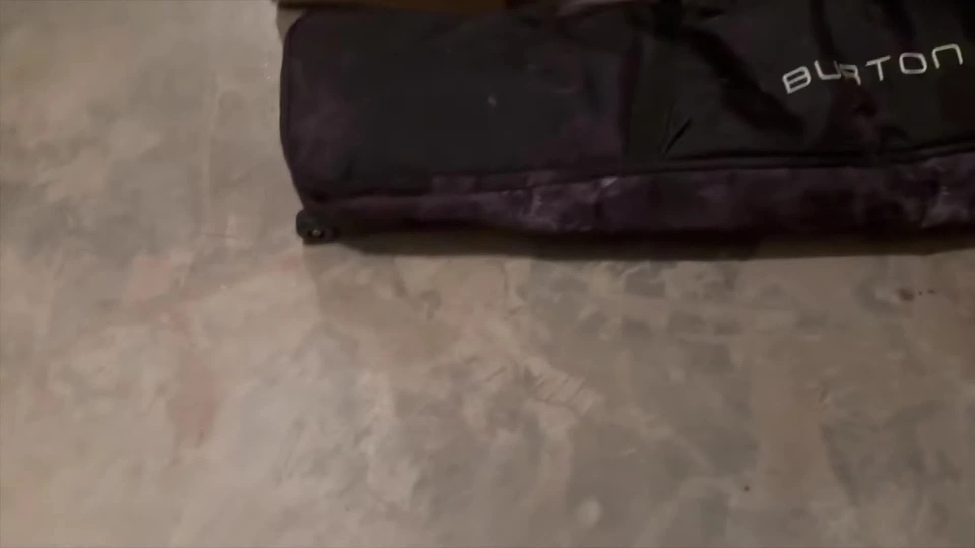 Close-up showcasing the bag's wheels and base support.