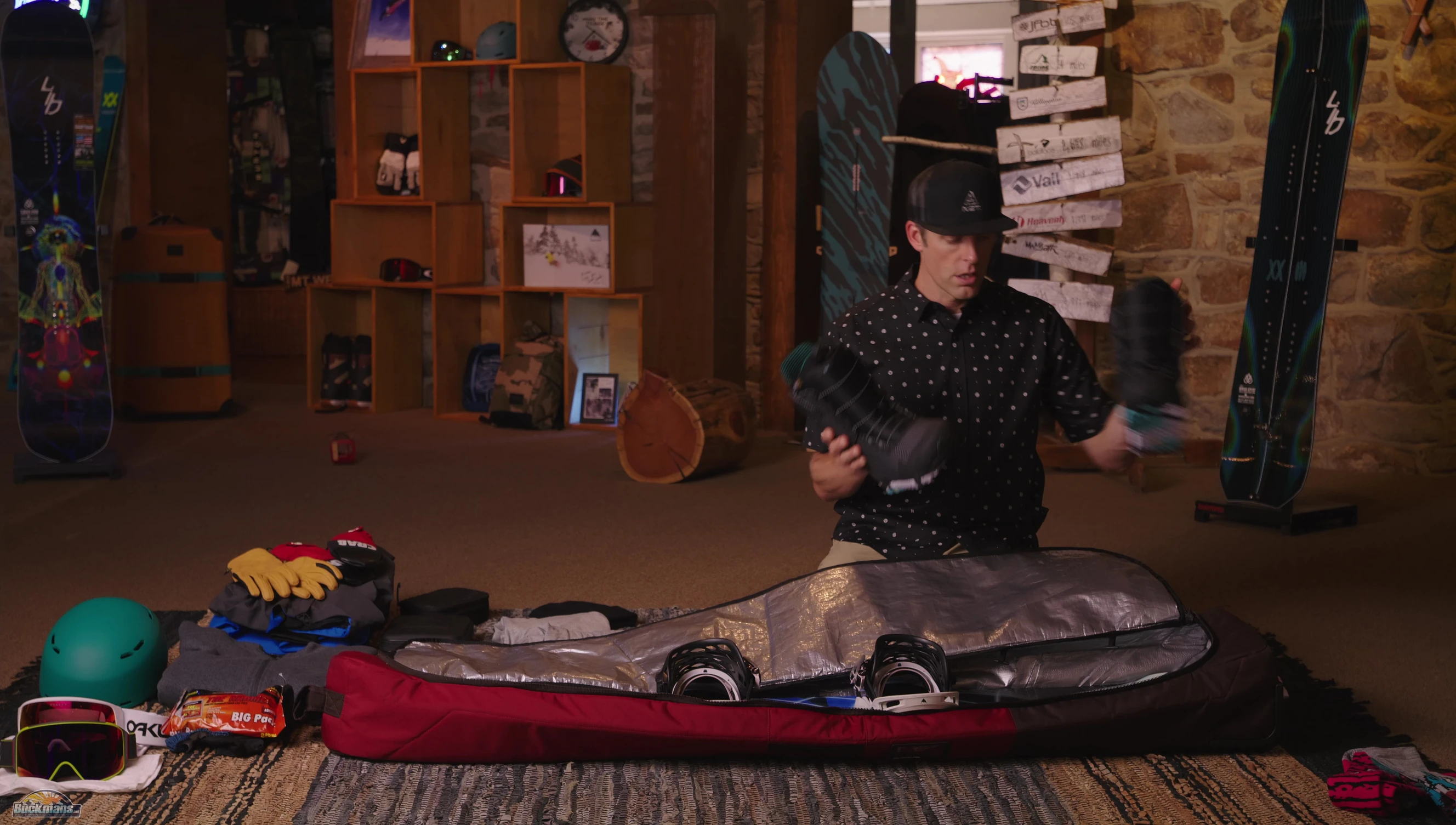 Snowboard boots placed near the wheels of the bag