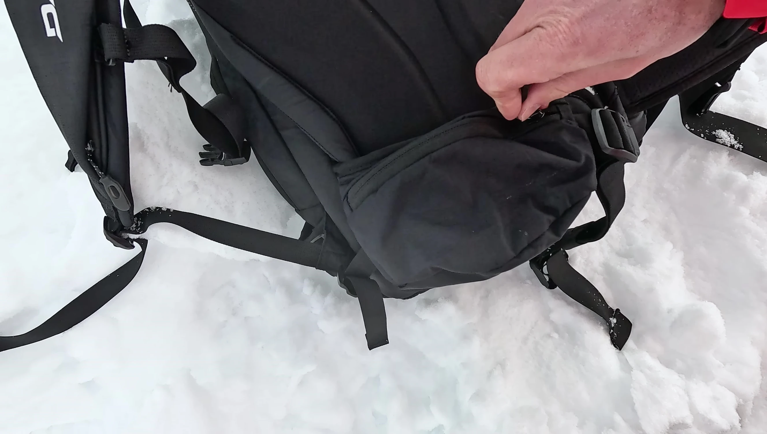 Small pocket on the hip belt, shown with batteries inside.