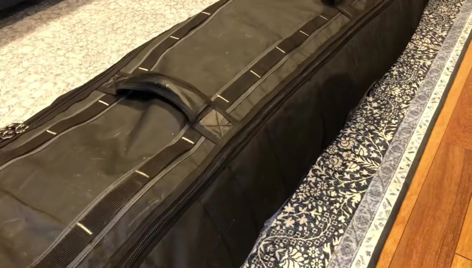 Close-up showing the overall condition of the ski bag after years of use, highlighting minor wear and tear.