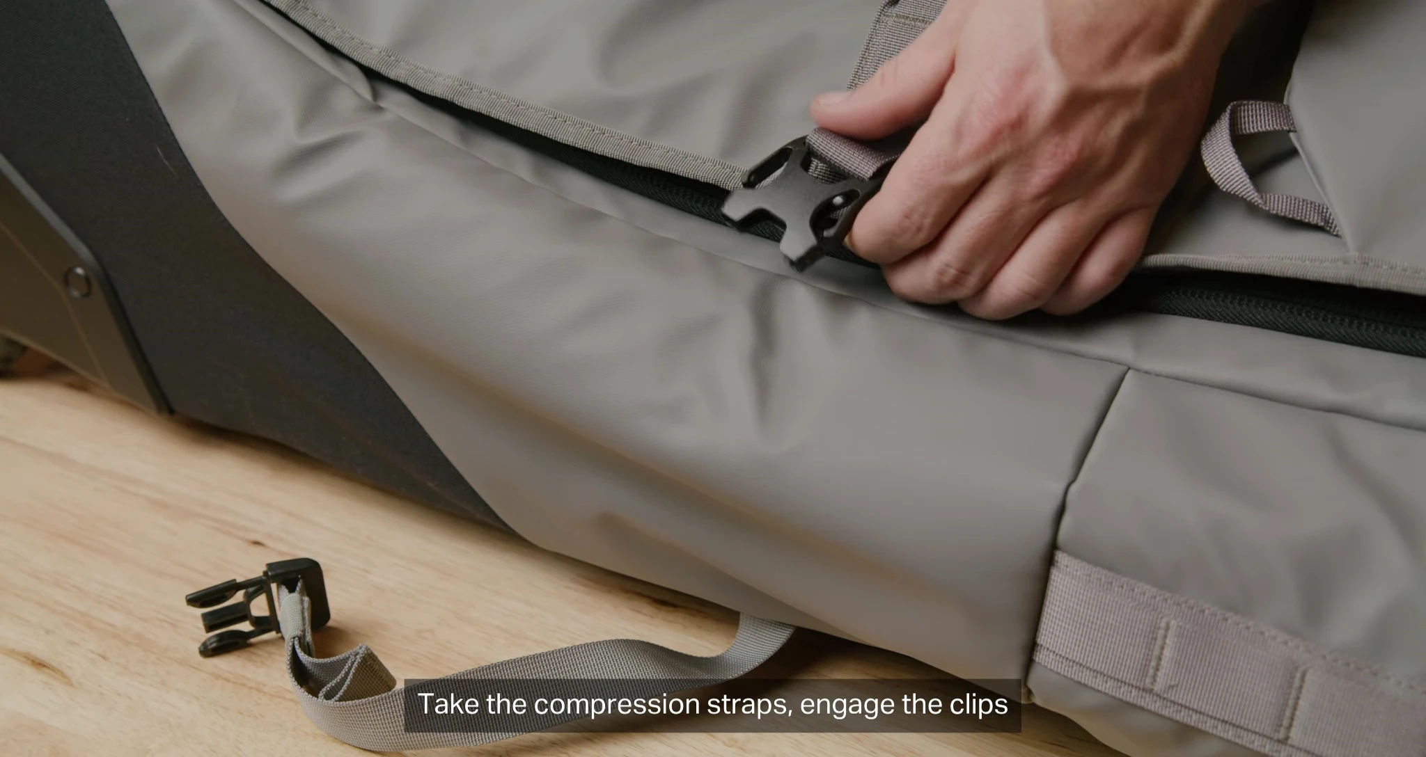 Tightening compression straps and securing the bag.