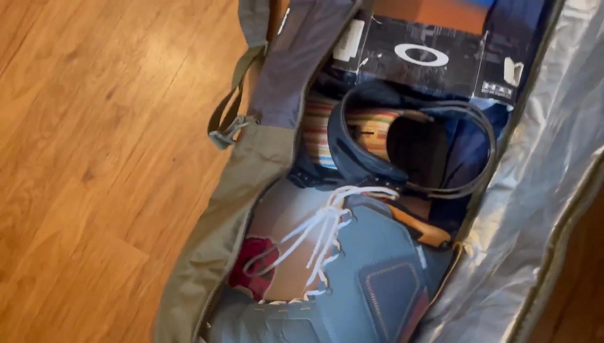 Shot showing boots and snowboards inside the bag.