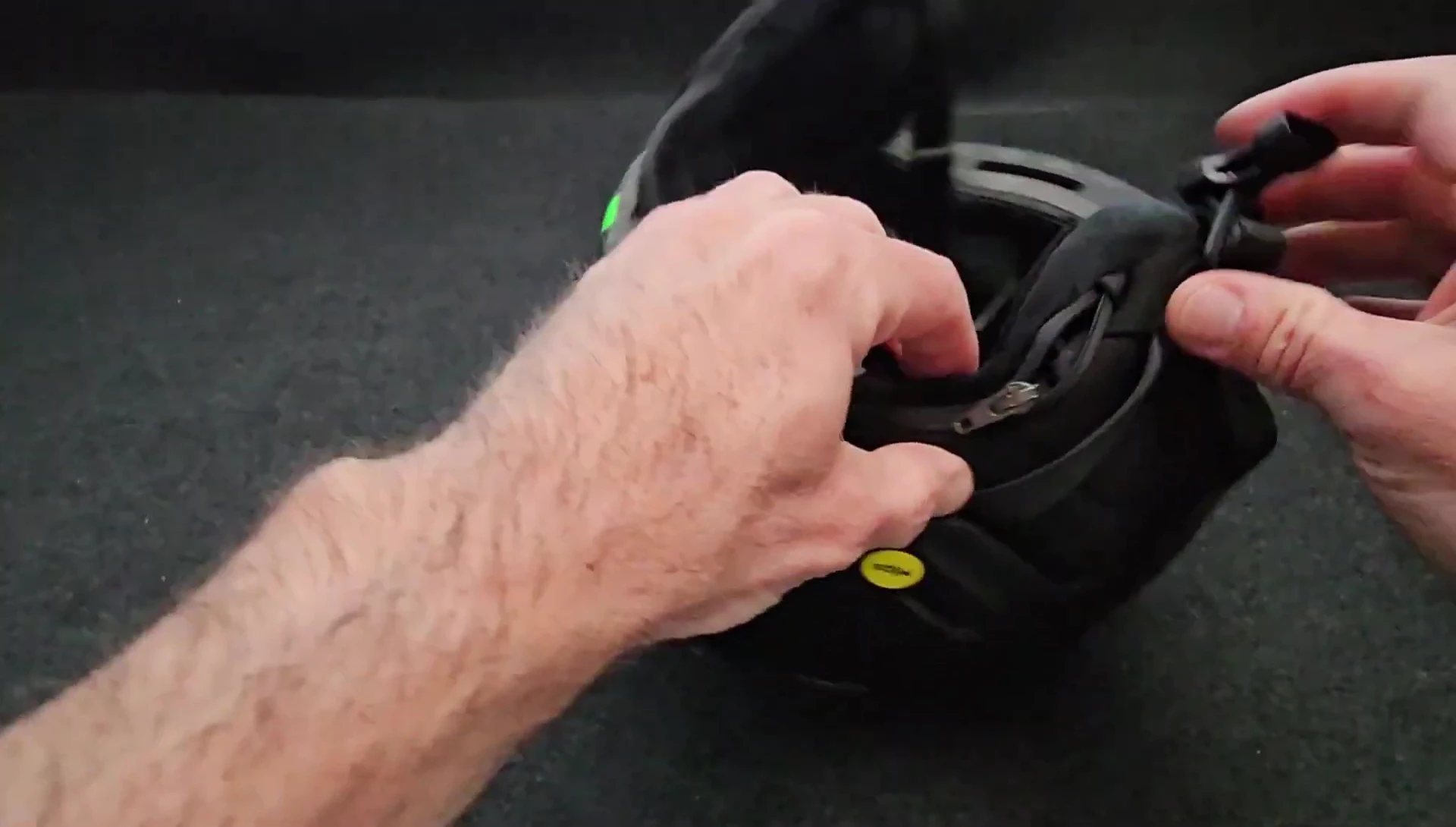 Close-up of the zippered compartment for headphone integration at the back of the helmet