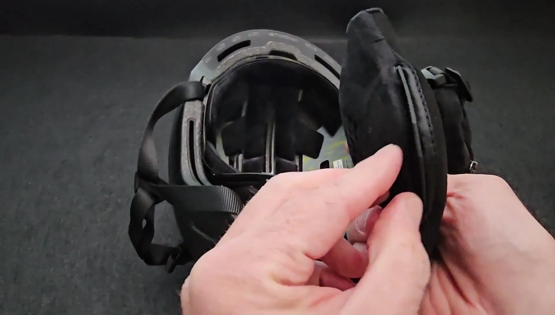 Demonstrating the ease of removing and reinstalling the ear pads.