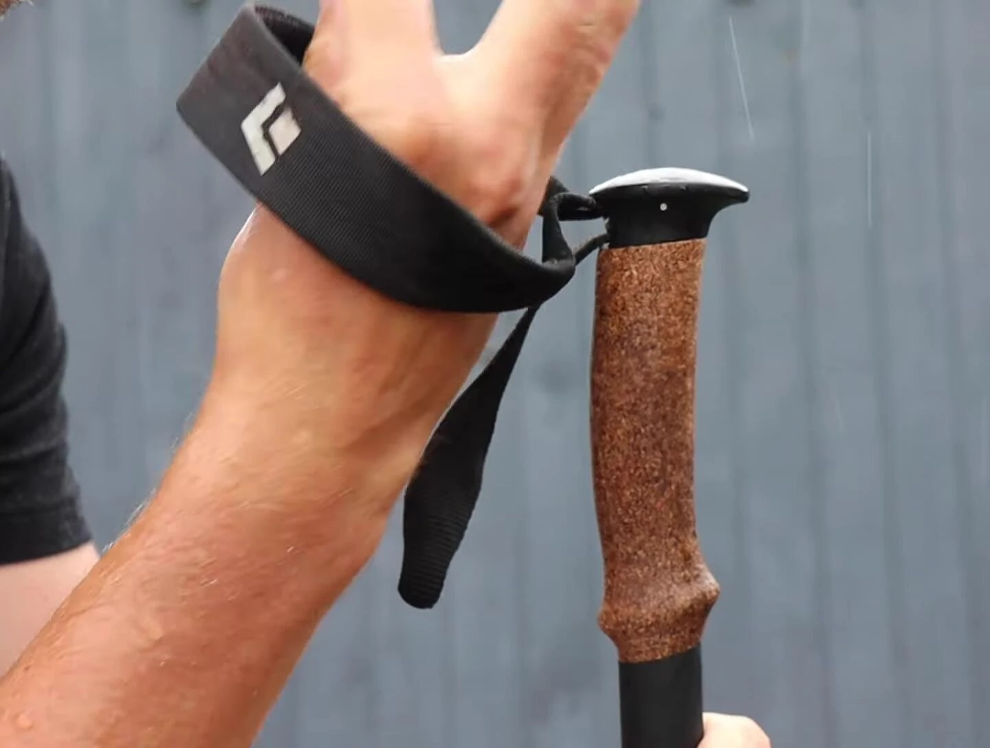 Hiker demonstrating traditional wrist strap technique