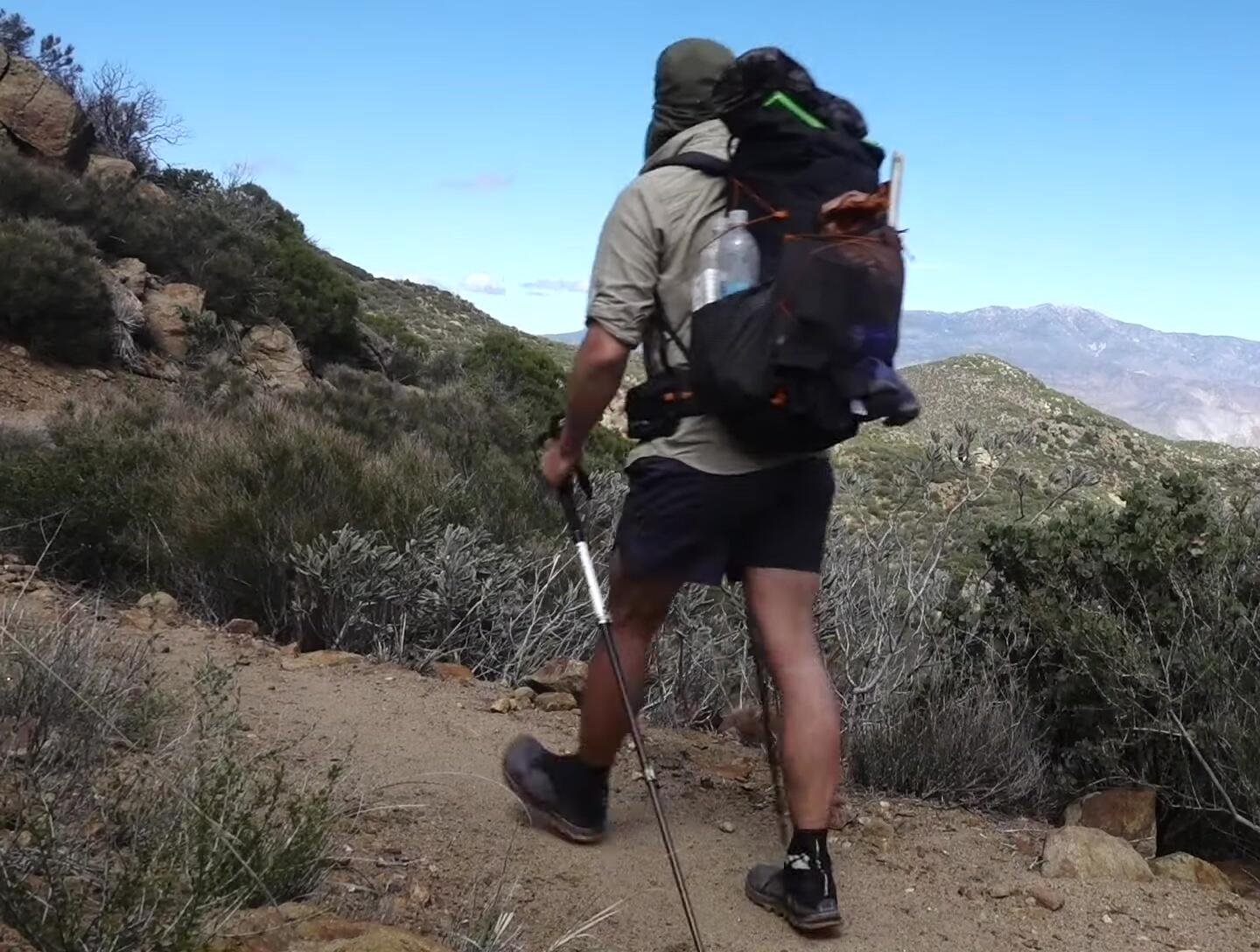 Close up shot of hands holding trekking poles
