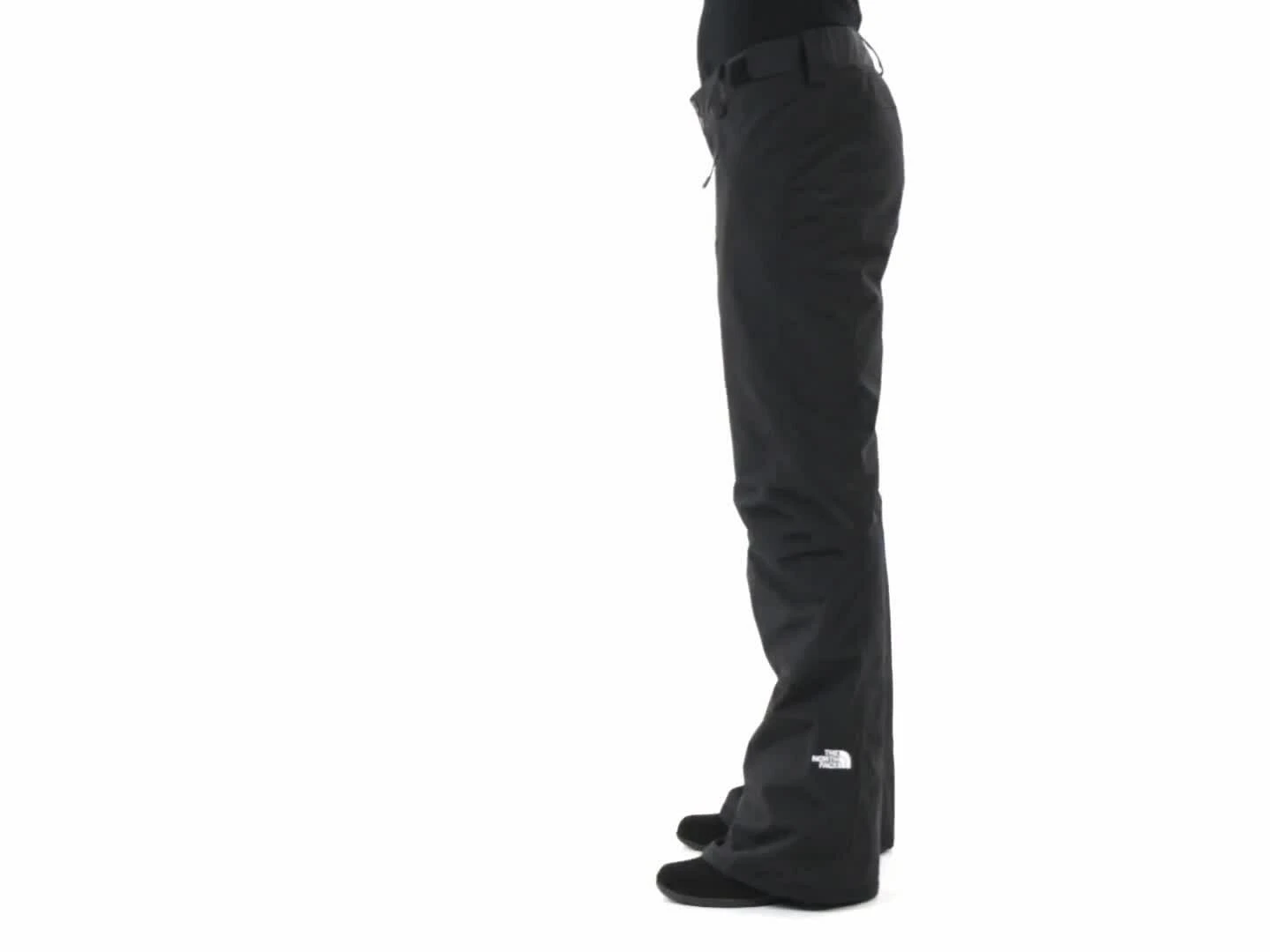 A model wearing the ski pants, highlighting the stylish, jeans-like fit.