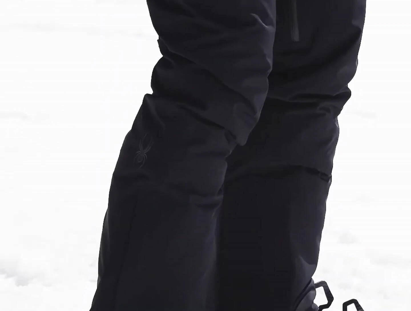 The reviewer showcasing the fit of the pants, emphasizing the fitted thigh and flared bottom.