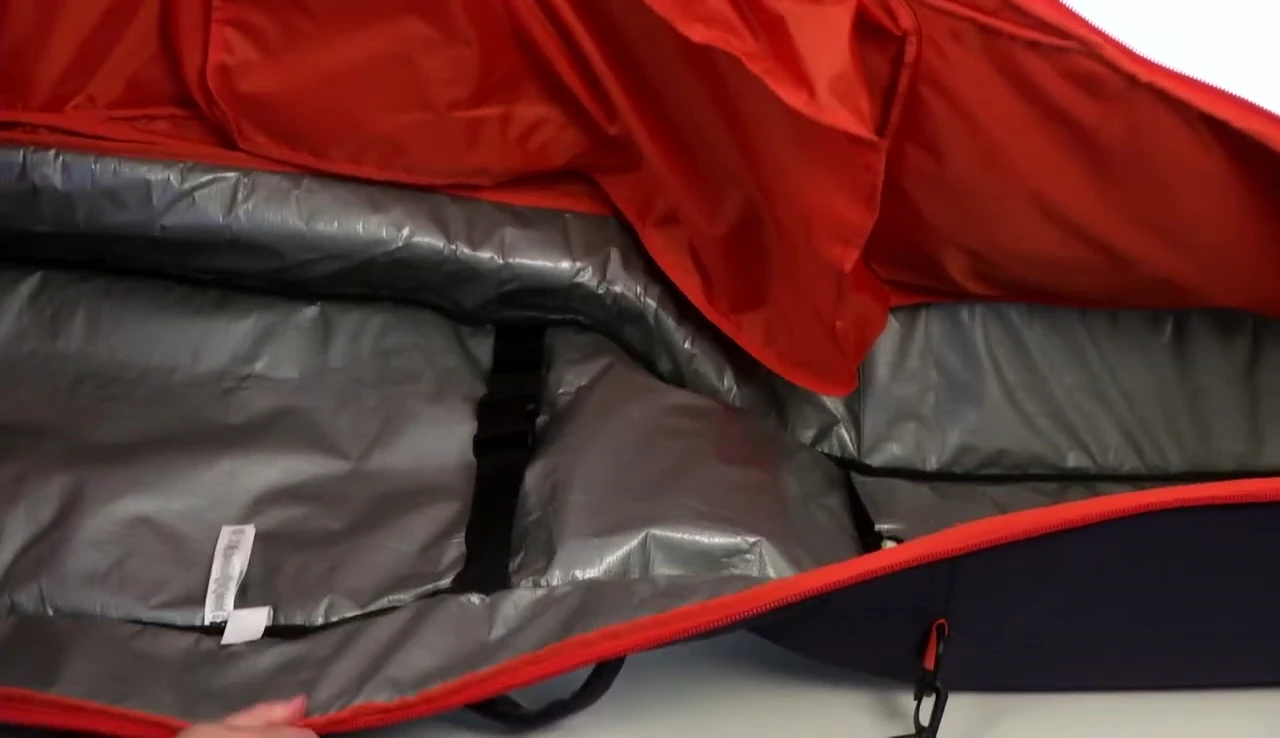 Interior straps for securing snowboards inside the bag.