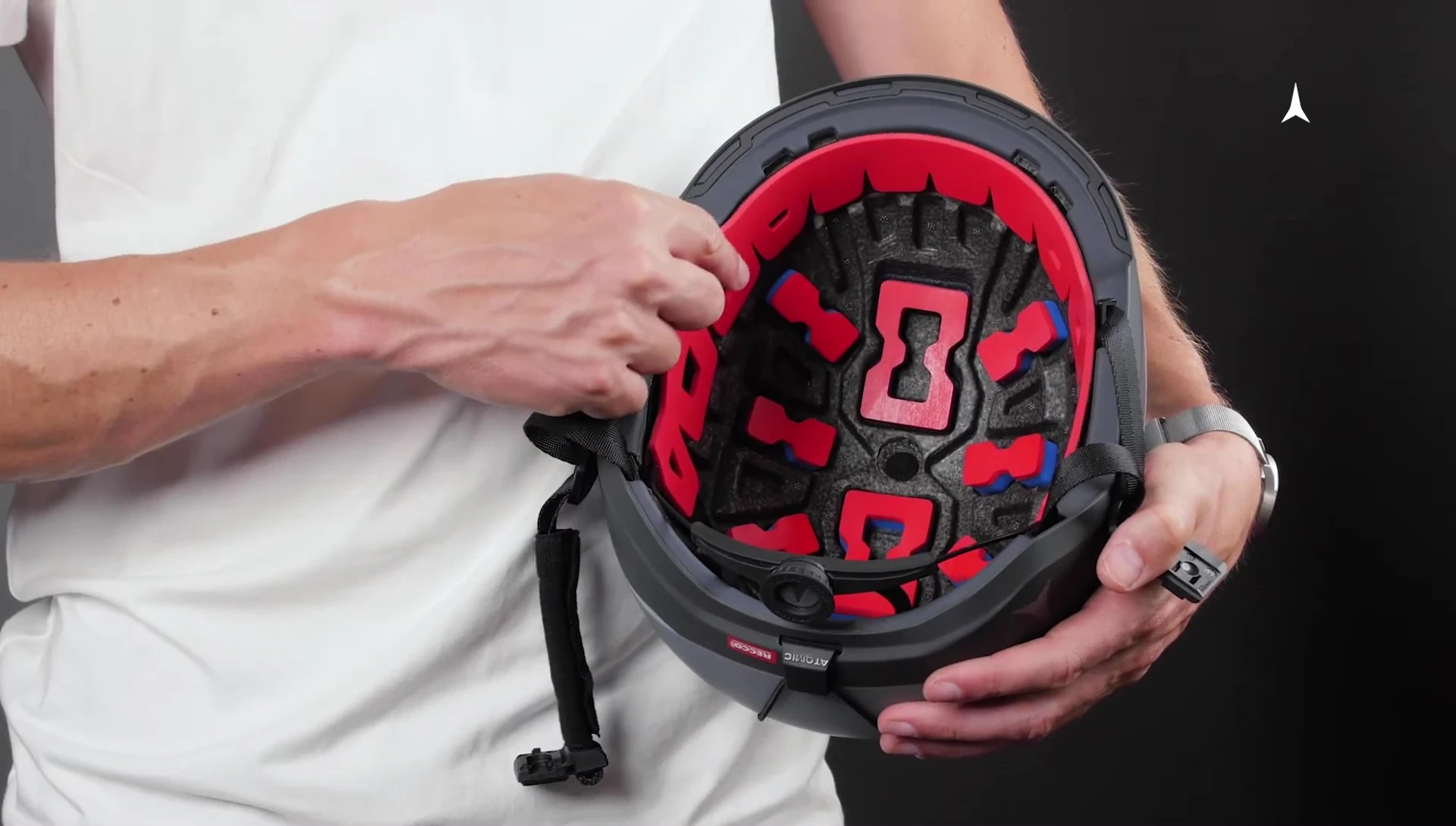 A person adjusting the 360 fit system on the helmet