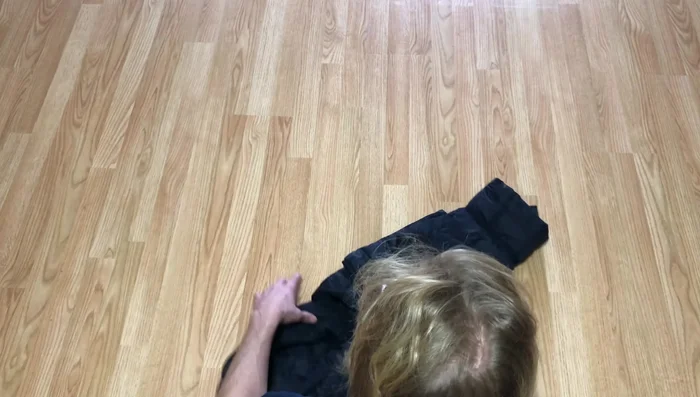 Use your hand to pull the cuff (from step 3) around the rolled coat, creating a 'coat burrito'.