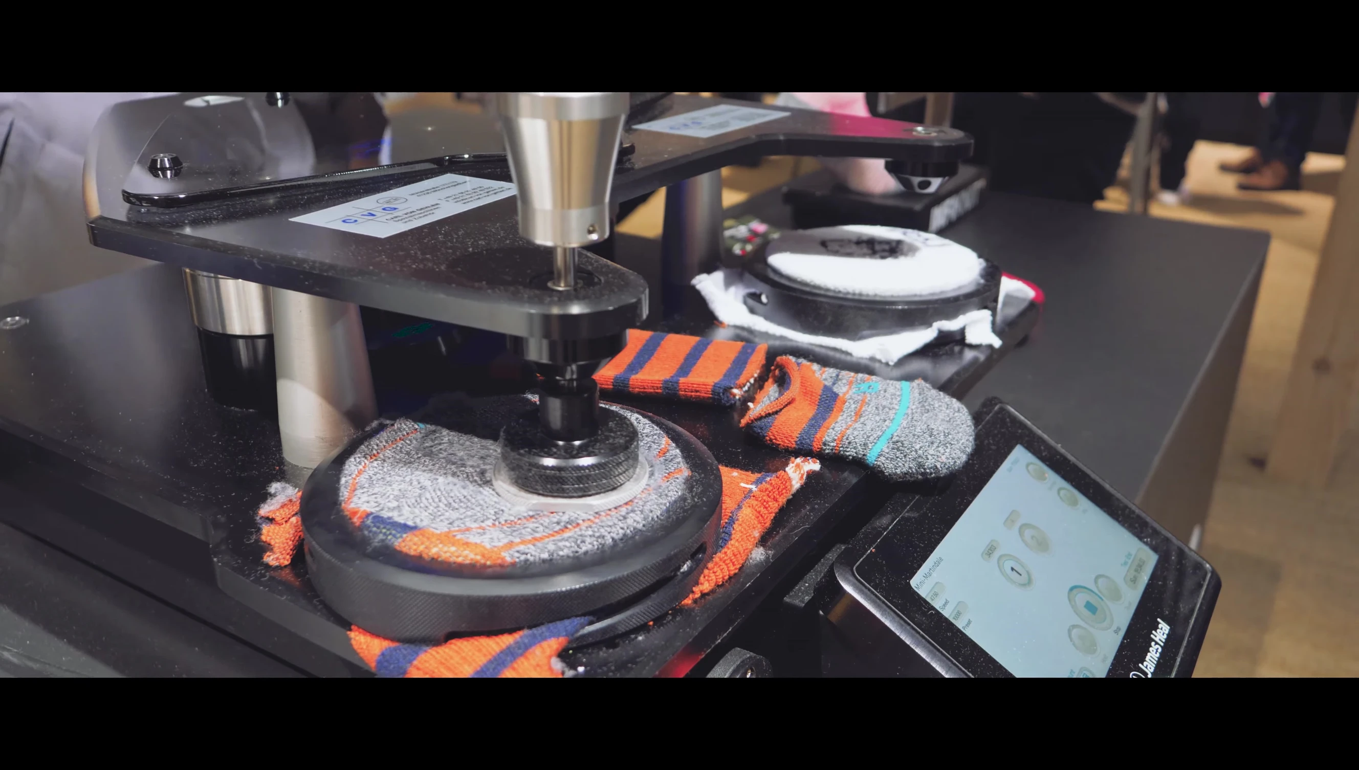 Close-up of the Martindale abrasion machine testing the Stance and competitor socks.
