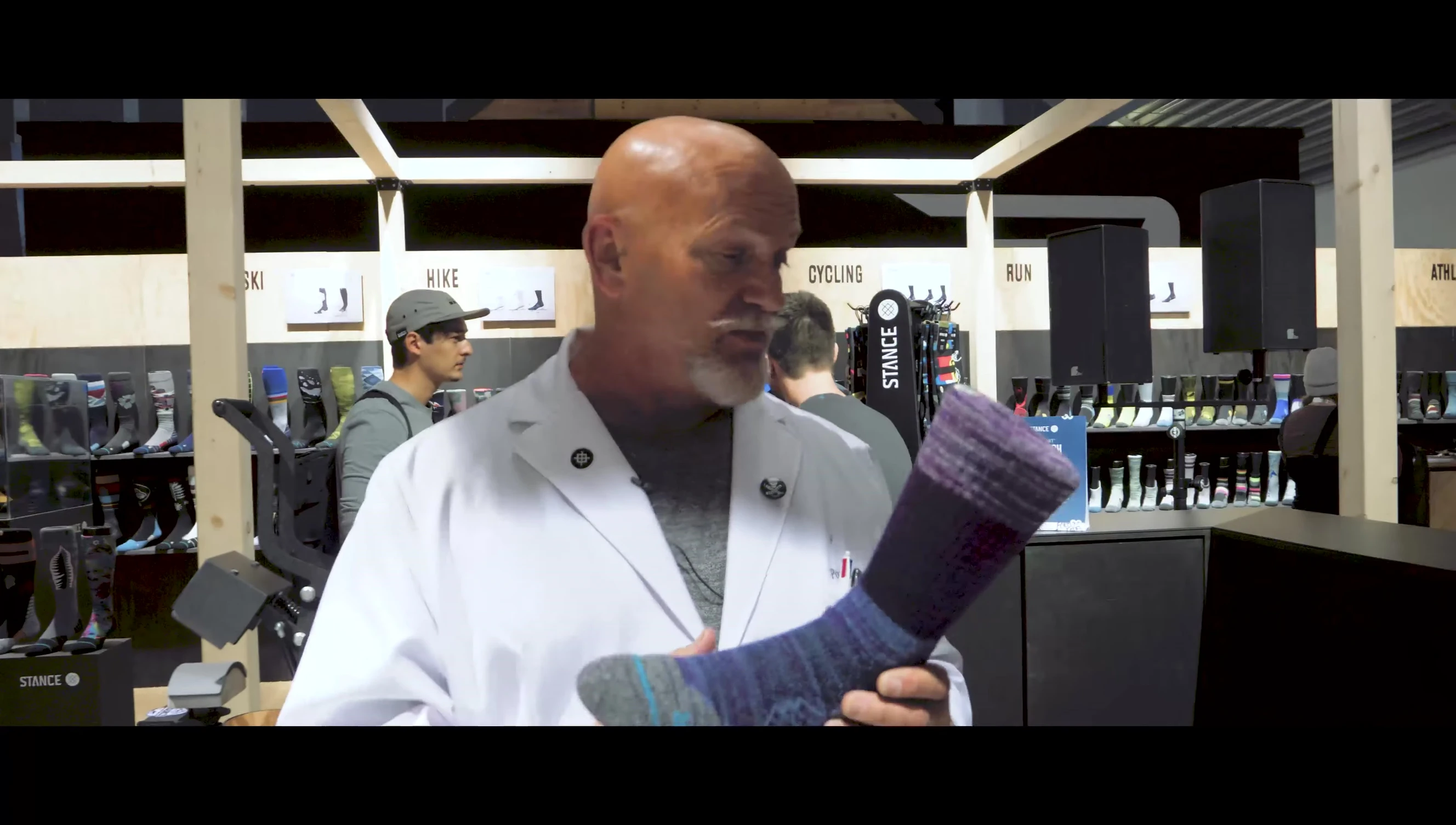 The presenter emphasizing the lifetime guarantee of Stance Infinite socks.