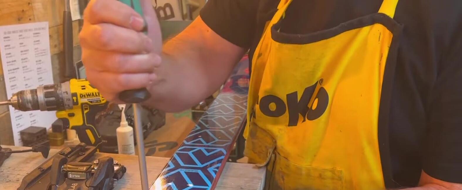Hand-tightening the screws in the toe piece
