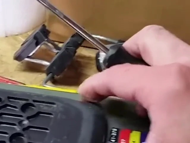 Demonstrating the action of sliding the plate forward to disengage tabs.
