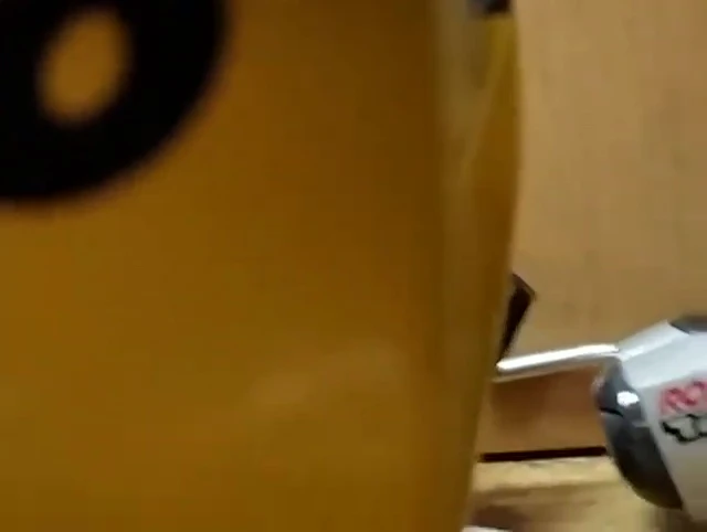 Using a screwdriver to gently pry up the plate.