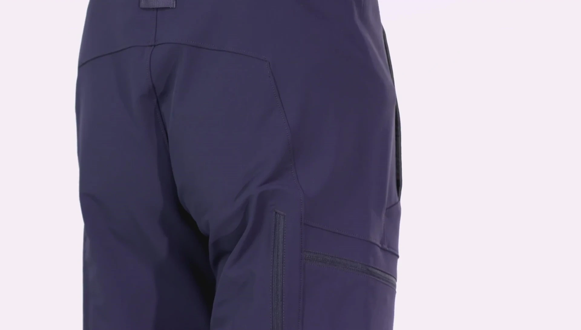 A person wearing the pants demonstrates the articulated patterning at the knees and legs, showcasing ease of movement.
